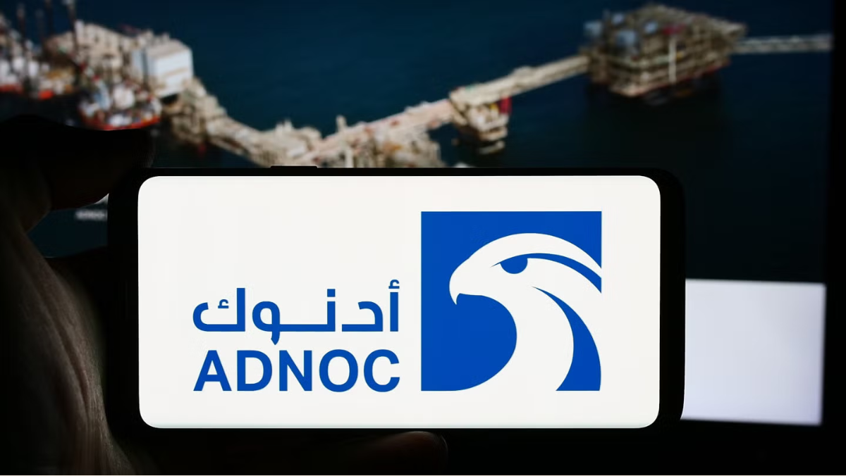 ADNOC logo displayed on a mobile screen with offshore oil and gas platforms in the background