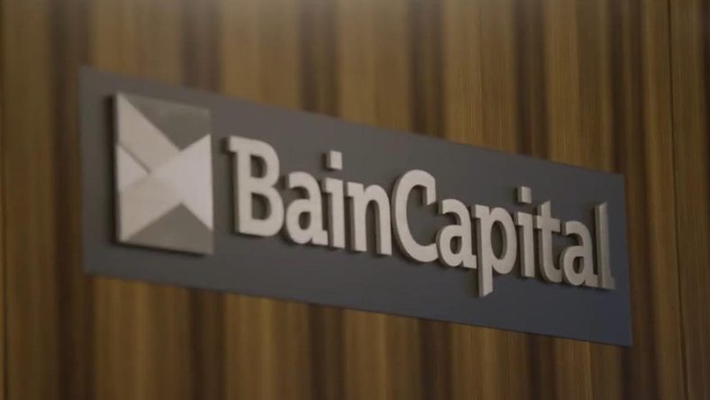 Bain Capital logo displayed on an interior office wall