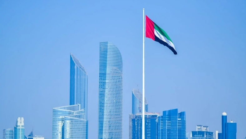 UAE flag flying above modern city skyline