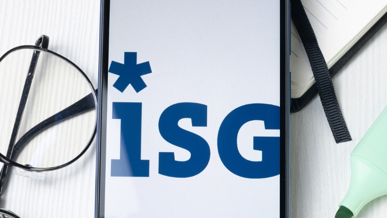 ISG logo displayed on smartphone screen beside glasses and notebook