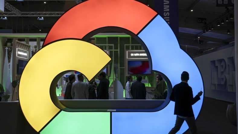 Google Cloud illuminated sign at a tech expo with attendees and Samsung signage